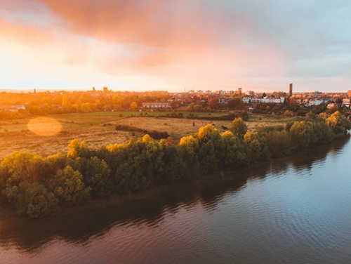 Aerial view of Chester with green fields and water