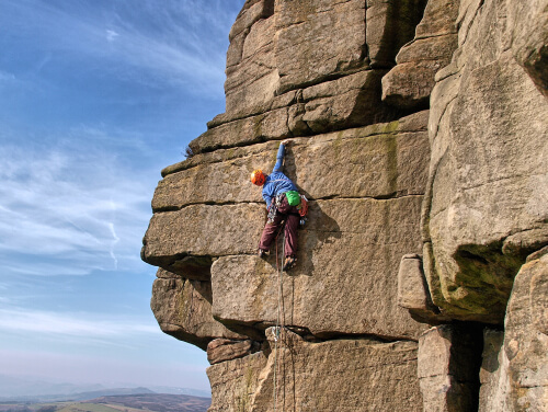 Man climbing up a cliff face