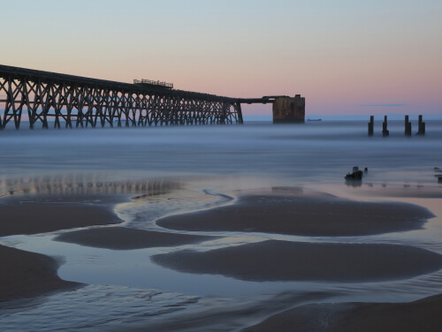 A view of the sunset and pier at Hartlepool Beach