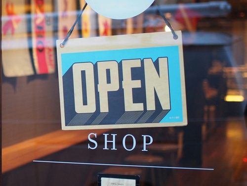 an open shop sign in a store window.